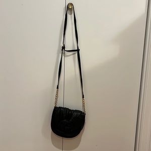 Black crossbody or shoulder bag with gold chain. Great for going out